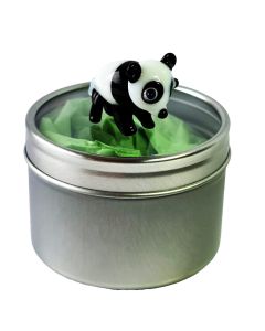Miniature glass panda standing on top of the clear lid of a round silver gift tin.